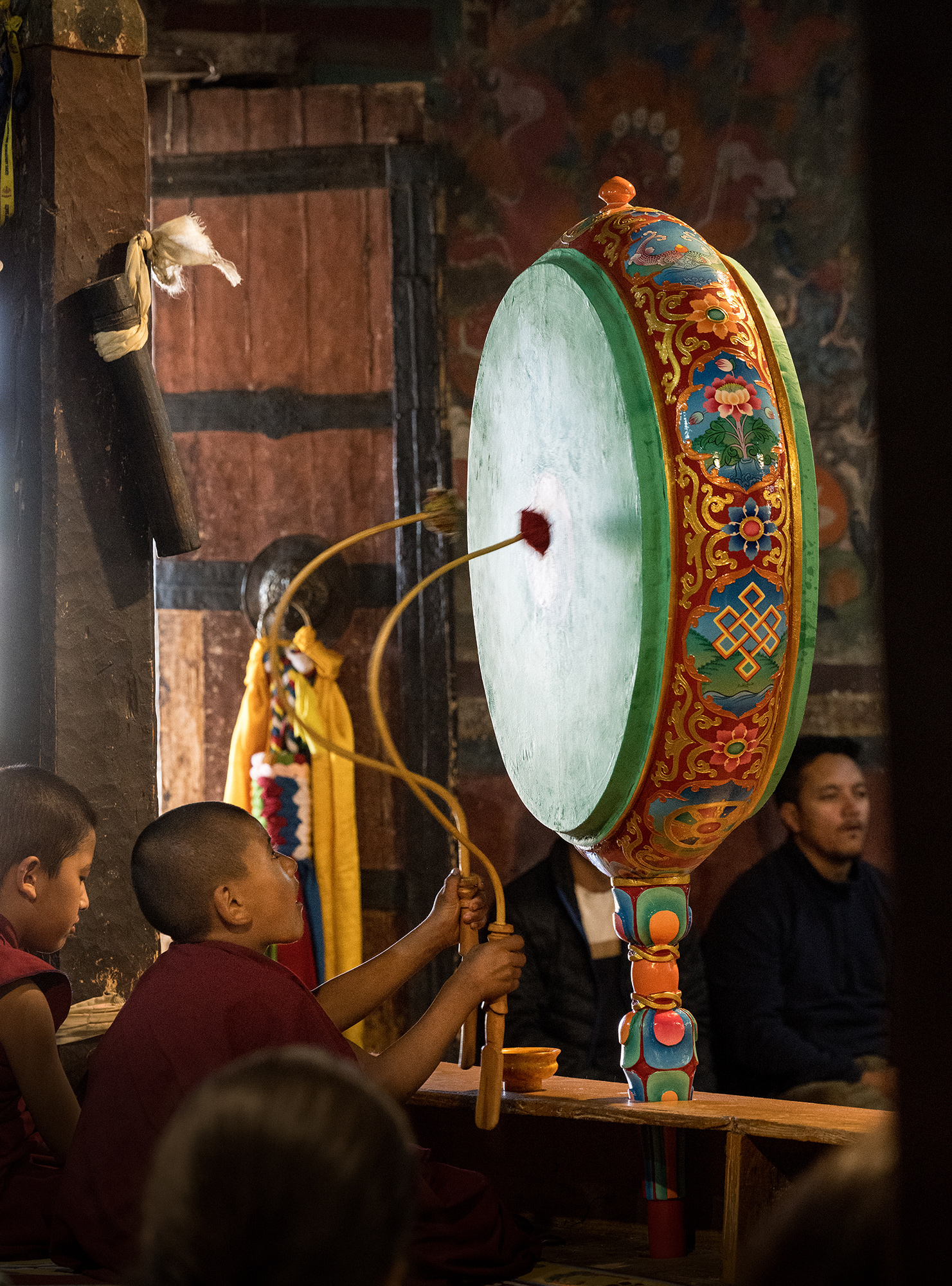 Au monastère Thiksey: jeune moine jouant d'un tambour chamanique